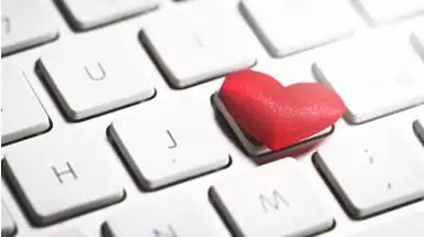 Get ready to fall inlove with email header A close up of a keyboard with a red heart on one key.