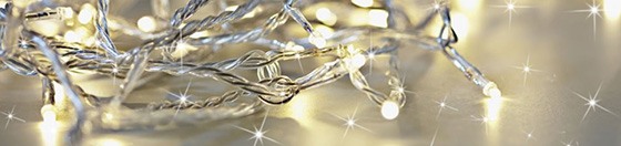 personal-touch A close-up of a string of fairy lights on a silver surface.