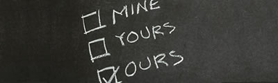 Sales and marketing The words Mine, Yours and Ours written as a checklist on a chalkboard, with a tick next to Ours.