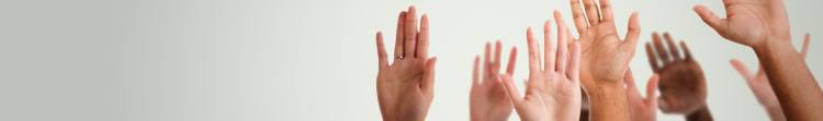 technical-faqs A close up of a group of raised hands.