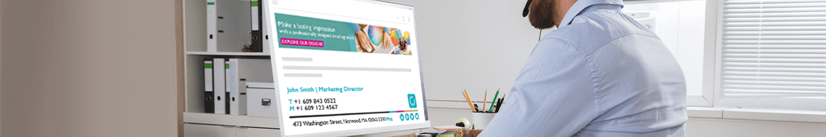 Email signatures meet remote working challenges A close-up of a man sitting at a laptop with a Rocketseed email banner and signature visible on screen.