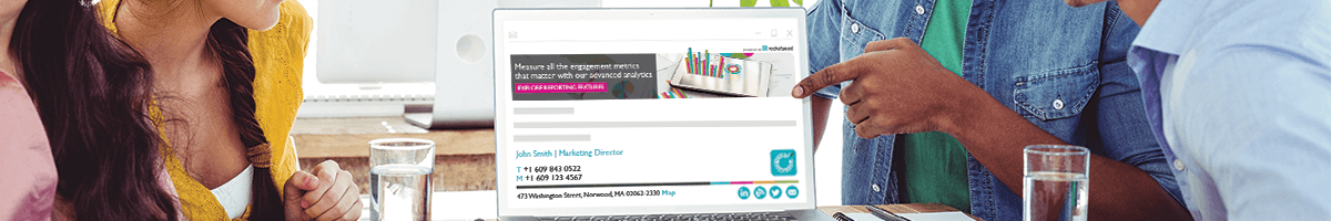 HTML email signature A man points to a laptop screen showing the Rocketseed email banner and signature; a woman looks at it.
