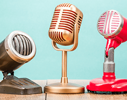 A row of three retro-looking microphones.