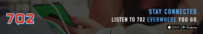 Stay connect app banner An email banner with the message "STAY CONNECTED LISTEN TO 7Q2 EVERYWHERE YOU GO" above the App Store and Google Play logos, with the 7Q2 logo on the left hand side, over an image of a woman holding a phone.